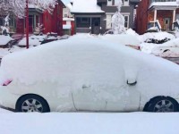 Snow-covered Prius shows depth from one-day storm in SLC.