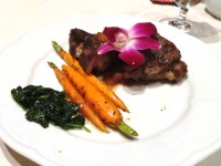 Organic spinach, carrots and lamb topped with a wildflower. 
Credit: Harriet Wallis