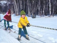 Riding the rope. Harriet's daughter Alison, 5, in leather boots and wooden skis on Jiminy Peak's rope tow. Credit: Harriet Wallis